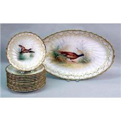 A SET OF TWELVE ENGLISH DINNER PLATES AND A SERVING PLATTER