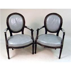A PAIR OF LOUIS XVI STYLE WALNUT CARVED ARMCHAIRS
