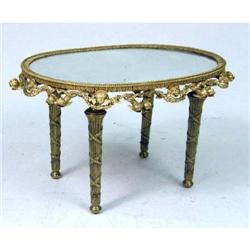 A LOUIS XVI STYLE GILT METAL OVAL GLASS TOP LOW TABLE