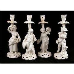 A SET OF FOUR FRENCH PORCELAIN CANDLESTICK FIGURALS