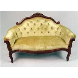 A DIMINUTIVE VICTORIAN CARVED MAHOGANY UPHOLSTERED LOVESEAT