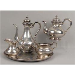 AN UNSTAMPED AMERICAN SILVER FOUR PIECE TEA SERVICE WITH CIRCULAR TRAY
