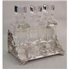 Image 1 : A VERY ORNATE SILVER PLATED FOOTED TANTALUS WITH THREE DECANTERS