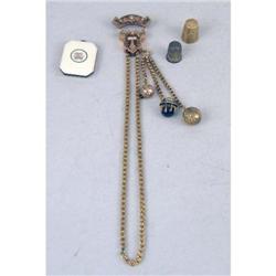 AN ANTIQUE YELLOW GOLD, BLACK ENAMEL AND PEARL SLIDE