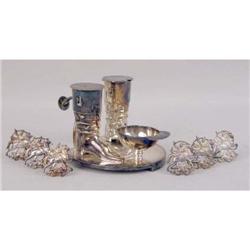 A SILVER-PLATED FIGURAL SALT SHAKER, PEPPER CASTER AND SALT DISH