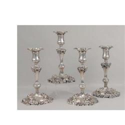 A SET OF FOUR TIFFANY & CO MAKERS ROCOCO SILVER SOLDERED CANDLESTICKS