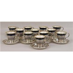 A SET OF TWELVE BAILEY, BANKS & BIDDLE STERLING SILVER DEMI-TASSE CUP HOLDERS WITH UNDERPLATES