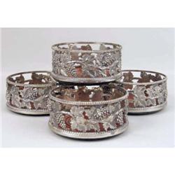 A SET OF FOUR SILVER PLATED WINE COASTERS