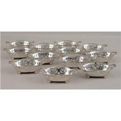 A SET OF TWELVE TIFFANY & CO. MAKERS STERLING SILVER SHAPED OVAL FOOTED NUT DISHES