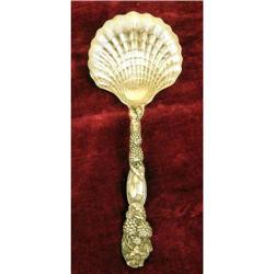A TIFFANY & CO. STERLING SILVER STRAWBERRY PATTERN SHELL-FORM BOWL SERVING SPOON