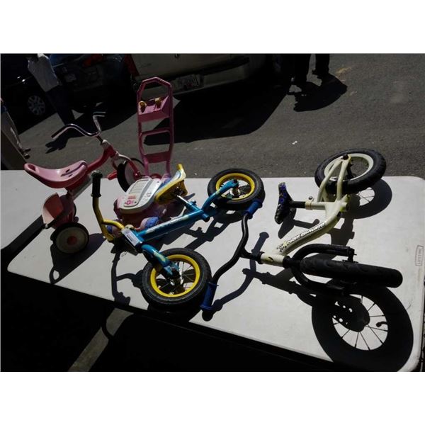 Two kids Strider bikes, tricycle and lawn mower toy