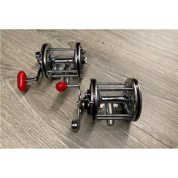 Pair of Immec 140-D level-wind fishing reels - burgundy with red handles