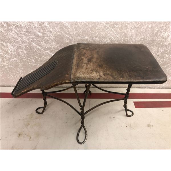 Antique shoe store stool features twisted metal base & leather padded seat