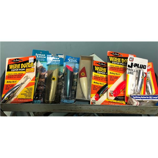 Group of 11 assorted fishing plugs in original packaging