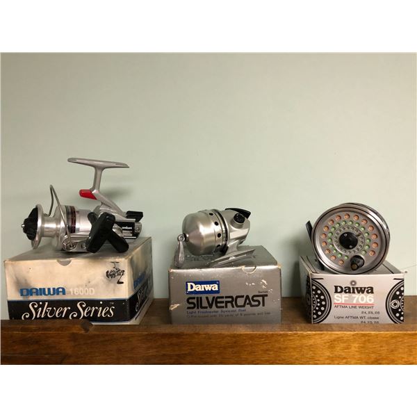 Three Daiwa fishing reels w/ original boxes - spinning reel/ bait cast reel/ fly reel