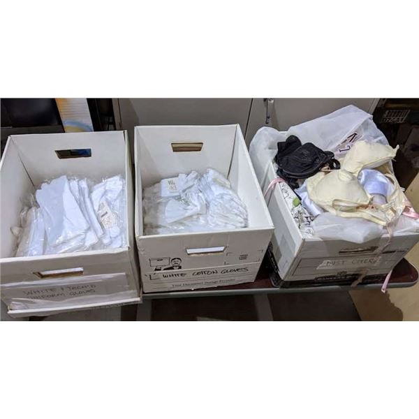 3 Boxes of white parade gloves and assorted bras from the show