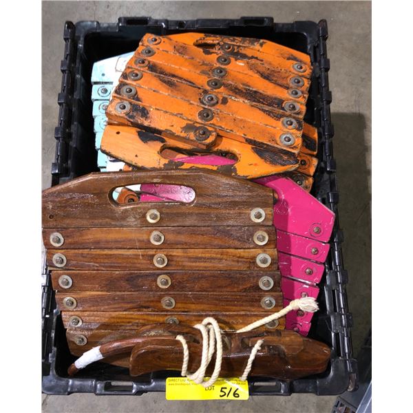 2 plastic storage totes filled with accordian style wooden boards