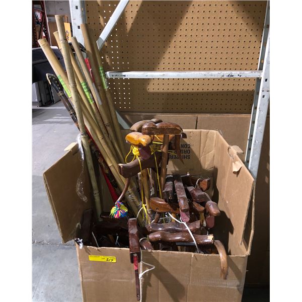 a box of assorted wooden canes and bamboo poles