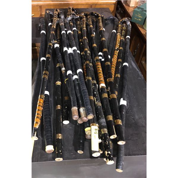 A large group of approx. 20 black bamboo canes