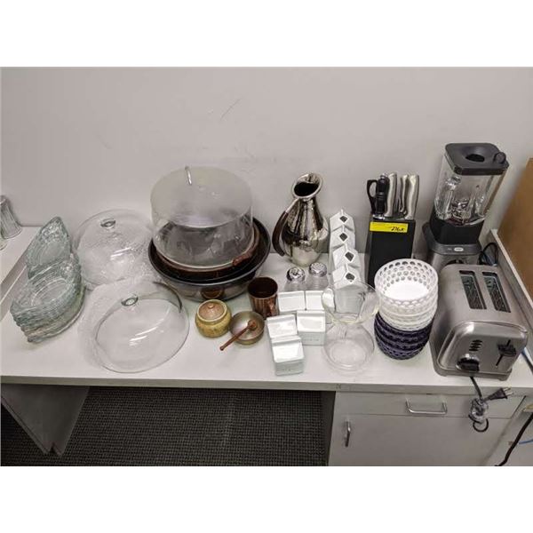 Table top of assorted serving pieces Breville blender, knive block with Knives etc.