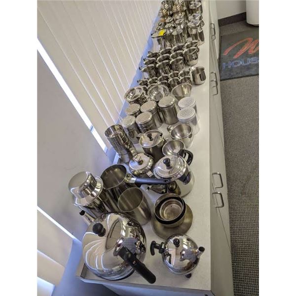 Table top full of assorted commercial serving pieces, shakers, tea kettles, creamers etc