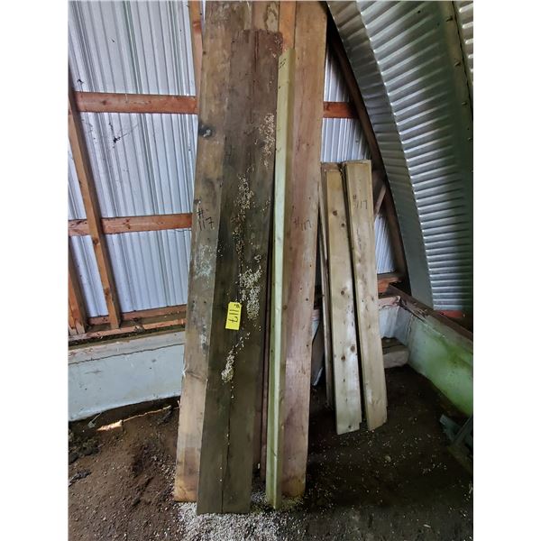 BUNDLE OF WOOD/LUMBER (AGAINST WALL)