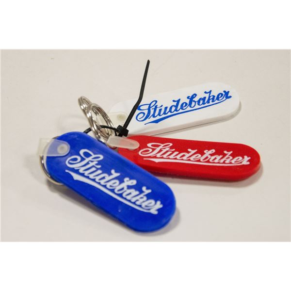 THREE STUDEBAKER KEY FOBS
