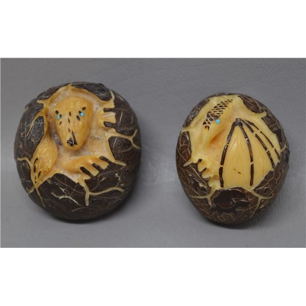 TWO HAND CARVED TEGUA NUTS ATTRIBUTED TO DERRICK KAMASEE