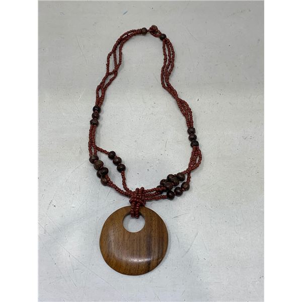 Brown beaded necklace with wooden pendant