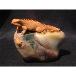 Stone carving in shape of a lizzard on a #1844719