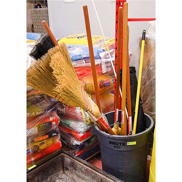 GARBAGE CAN FULL OF BROOMS AND SAFETY FLAG