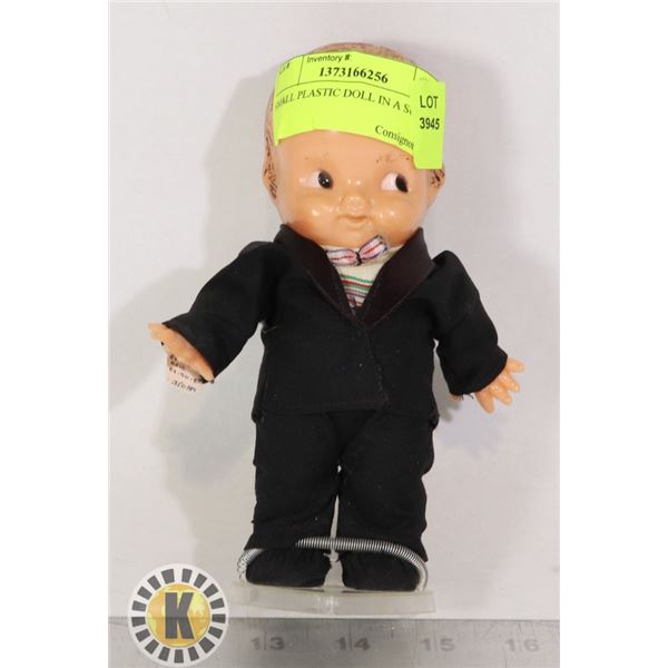 SMALL PLASTIC DOLL IN A SUITE