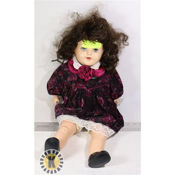 PLASTIC DOLL IN A PURPLE DRESS