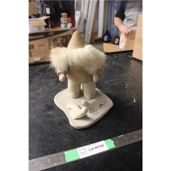 Inuit Man with Seals Sandstone Art