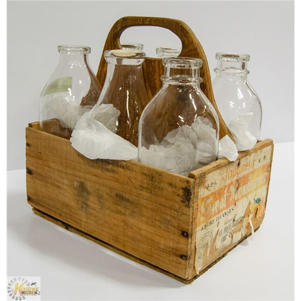 OLD MILK BOTTLES IN WOODEN CRATE