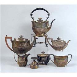 AN ENGLISH STERLING SILVER WOODEN HANDLED SMALL TEAPOT