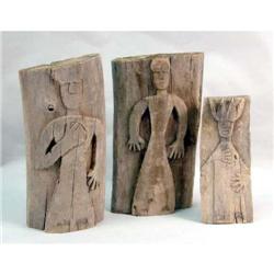 THREE PRIMITIVE HUMAN-FORM WOOD CARVINGS