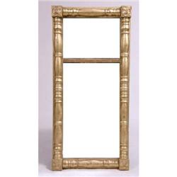 A LATE CLASSICAL GILTWOOD LOOKING GLASS