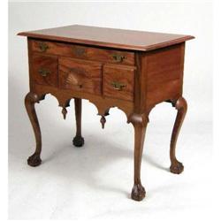 A CHIPPENDALE-STYLE CARVED AND FIGURED MAHOGANY DRESSING TABLE