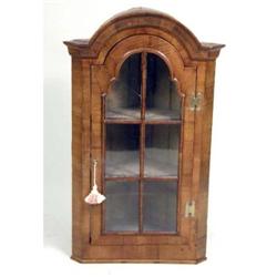 A QUEEN ANNE FIGURED WALNUT HANGING CORNER CABINET