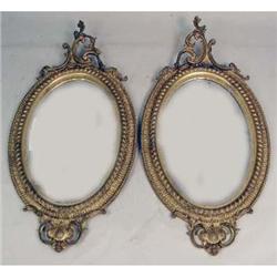 A PAIR OF VICTORIAN GILTWOOD OVAL LOOKING GLASSES