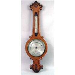 A VICTORIAN CARVED AND FIGURED OAK "BANJO" BAROMETER