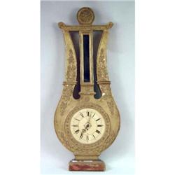 A GILTWOOD APPLIED GESSO LYRE FORM WALL CLOCK