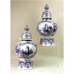 A PAIR OF BLUE AND WHITE DELFT COVERED URNS
