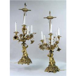 A PAIR OF CHERUB-FORM GILT METAL TABLE LAMPS
