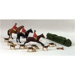 A CARVED WOOD POLYCHROME- DECORATED FOX HUNT FIGURAL GROUP