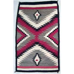 A NATIVE AMERICAN EARTHTONE WOVEN RUG