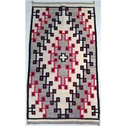 AN EARTHTONE GEOMETRIC NATIVE AMERICAN WOVEN RUG