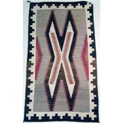 A NATIVE AMERICAN EARTHTONE WOVEN RUG
