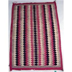 A POLYCHROME DIAMOND PATTERN NATIVE AMERICAN WOVEN RUG